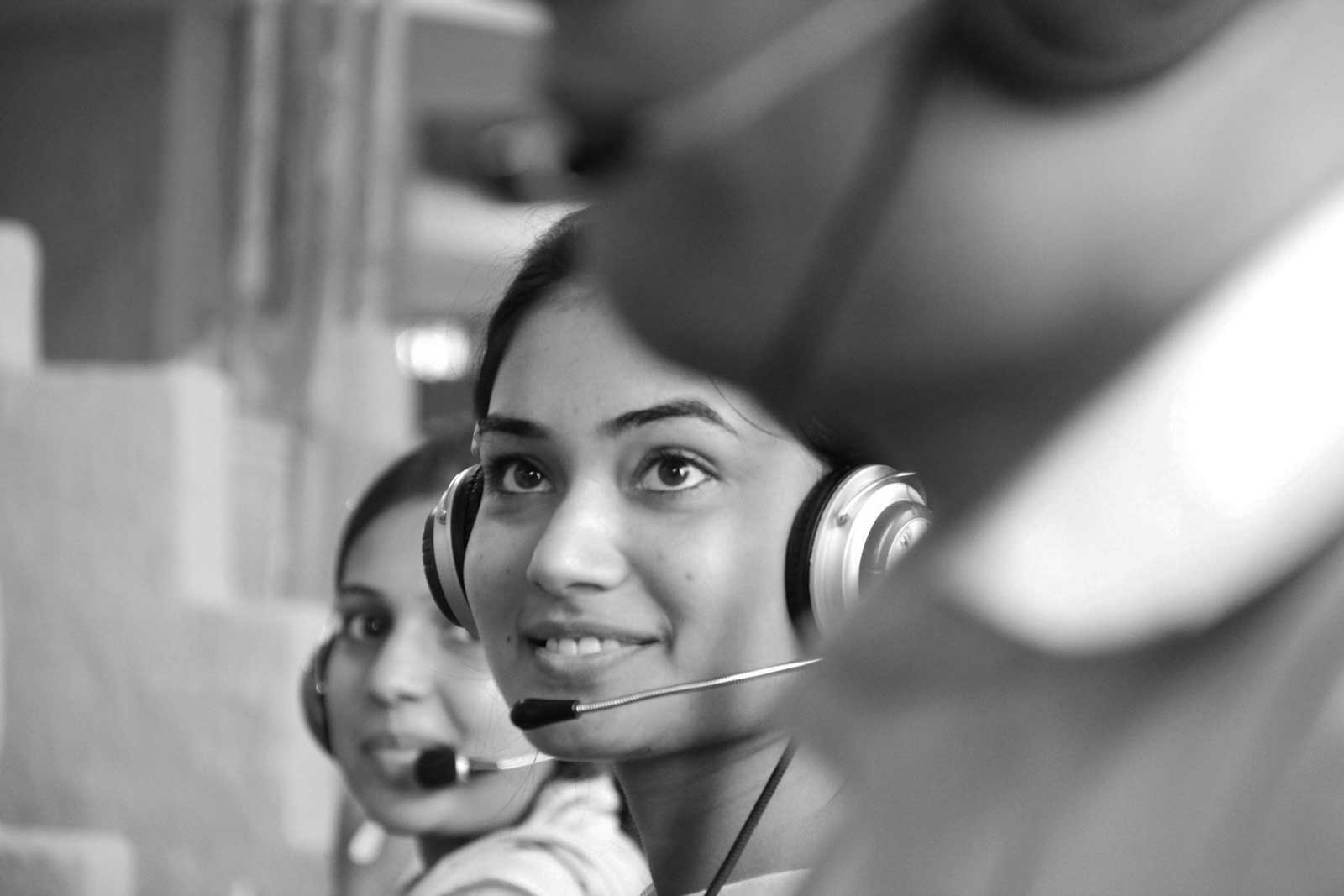 A close-up of three market research telephone interviewers.